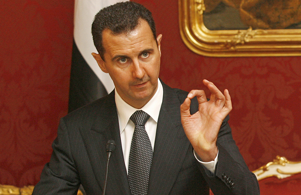 Syrian President Bashar al-Assad gives a