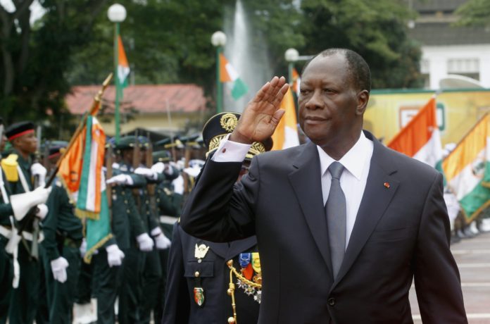 Ivory Coast's President Ouattara salutes during a parade to commemorate the country's 54th Independence Day, outside the presidential palace in Abidjan