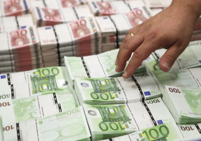 Wads of 10 and 100 euro banknotes are stacked at the GSA company's headquarters in Vienna